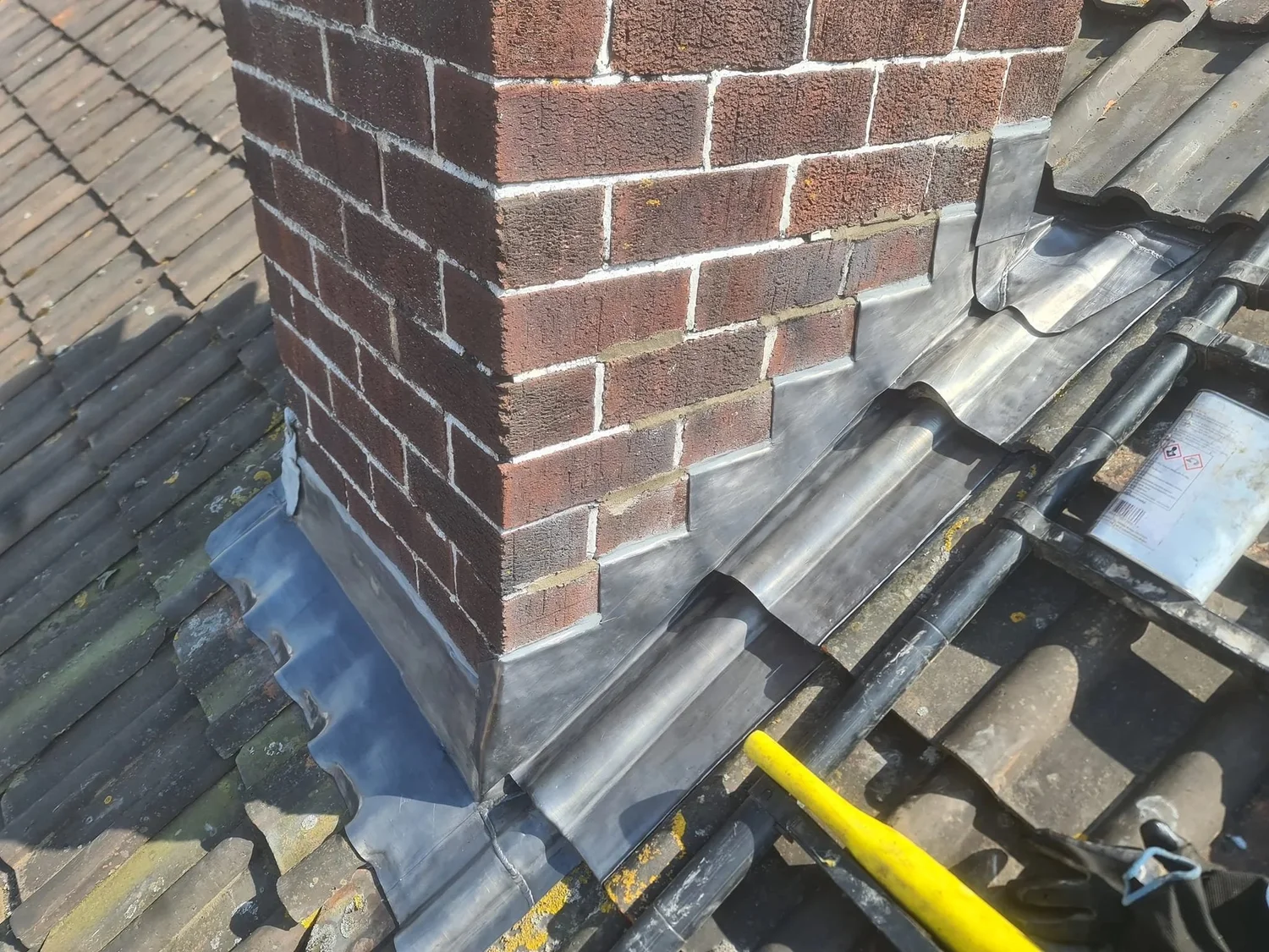 Finished stepped lead flashing around a chimney