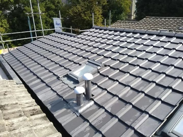 Completed pitched tiled roof with rooflights and vents